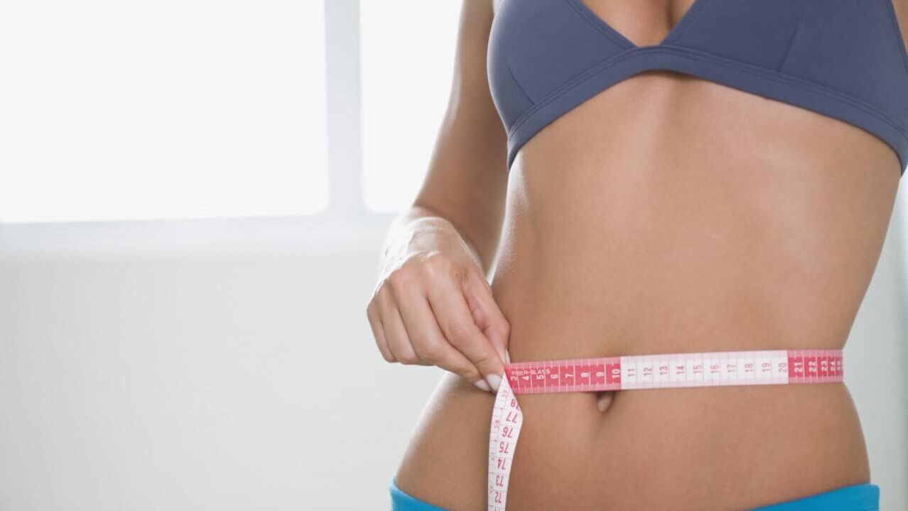 Das Mädchen misst die Taille